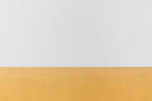 a white and yellow wall with a black and white clock