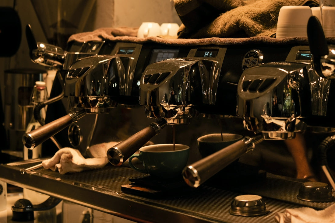 a row of espresso machines sitting on top of a counter