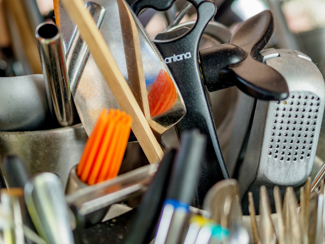 a pile of kitchen utensils and other kitchen utensils