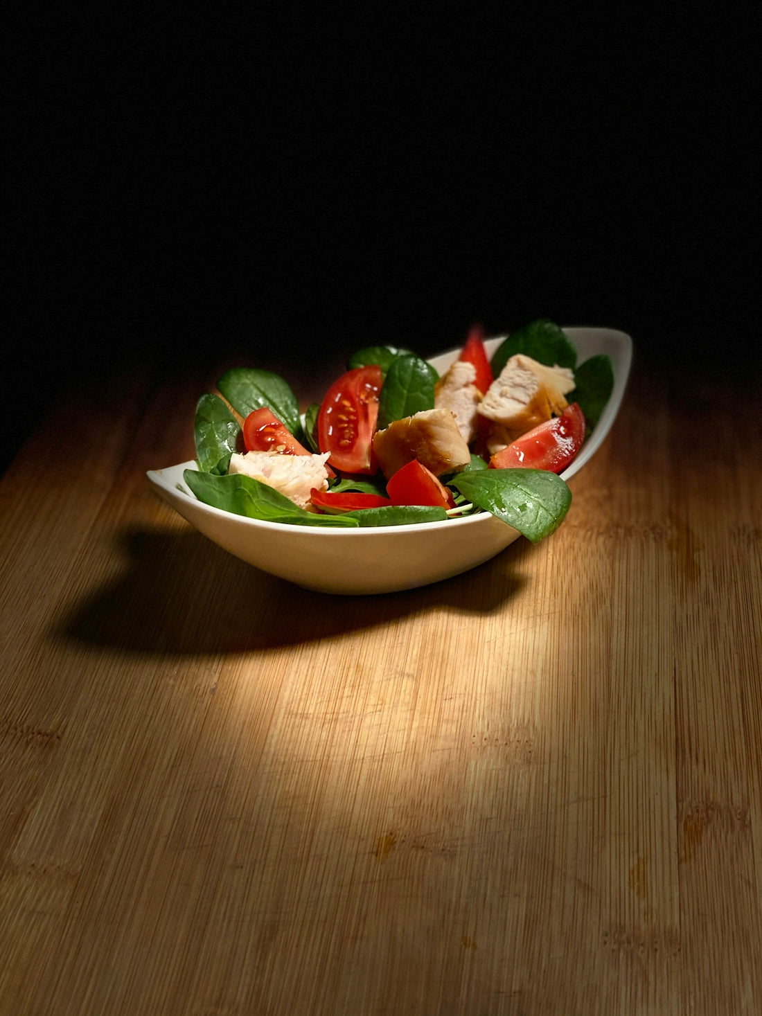 a white bowl filled with a salad on top of a wooden table