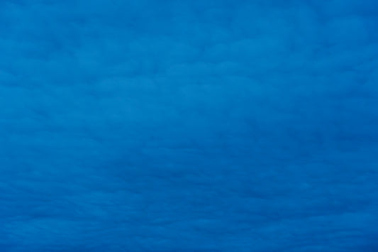 An airplane is flying high in the sky