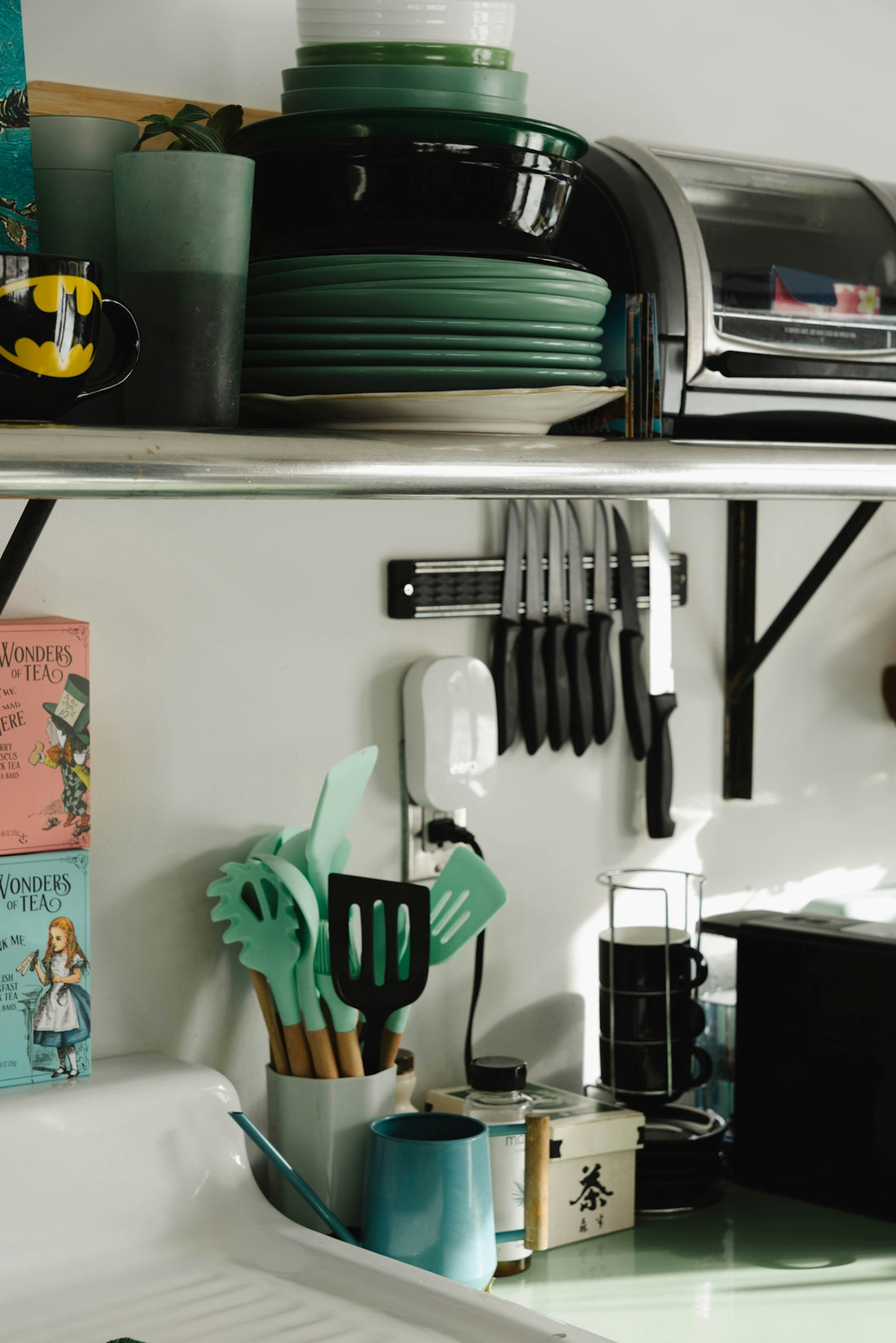 A kitchen counter with a bunch of utensils on it