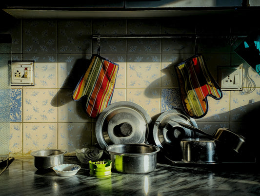 Kitchen pots and pans with oven mitts.