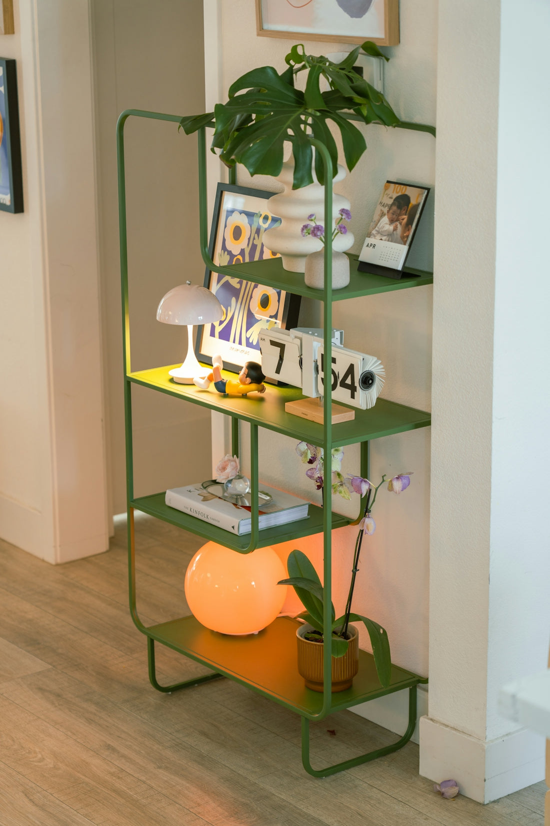A green shelf unit with various decorative items.