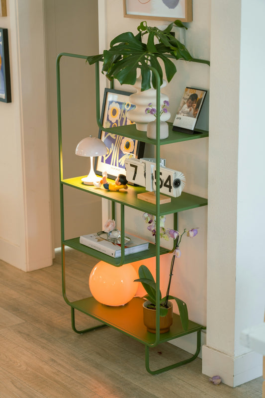 A green shelf unit with various decorative items.