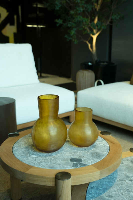 Two vases sit on a decorative coffee table.