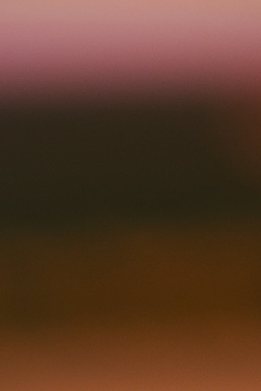 A soft gradient of brown and pink hues.