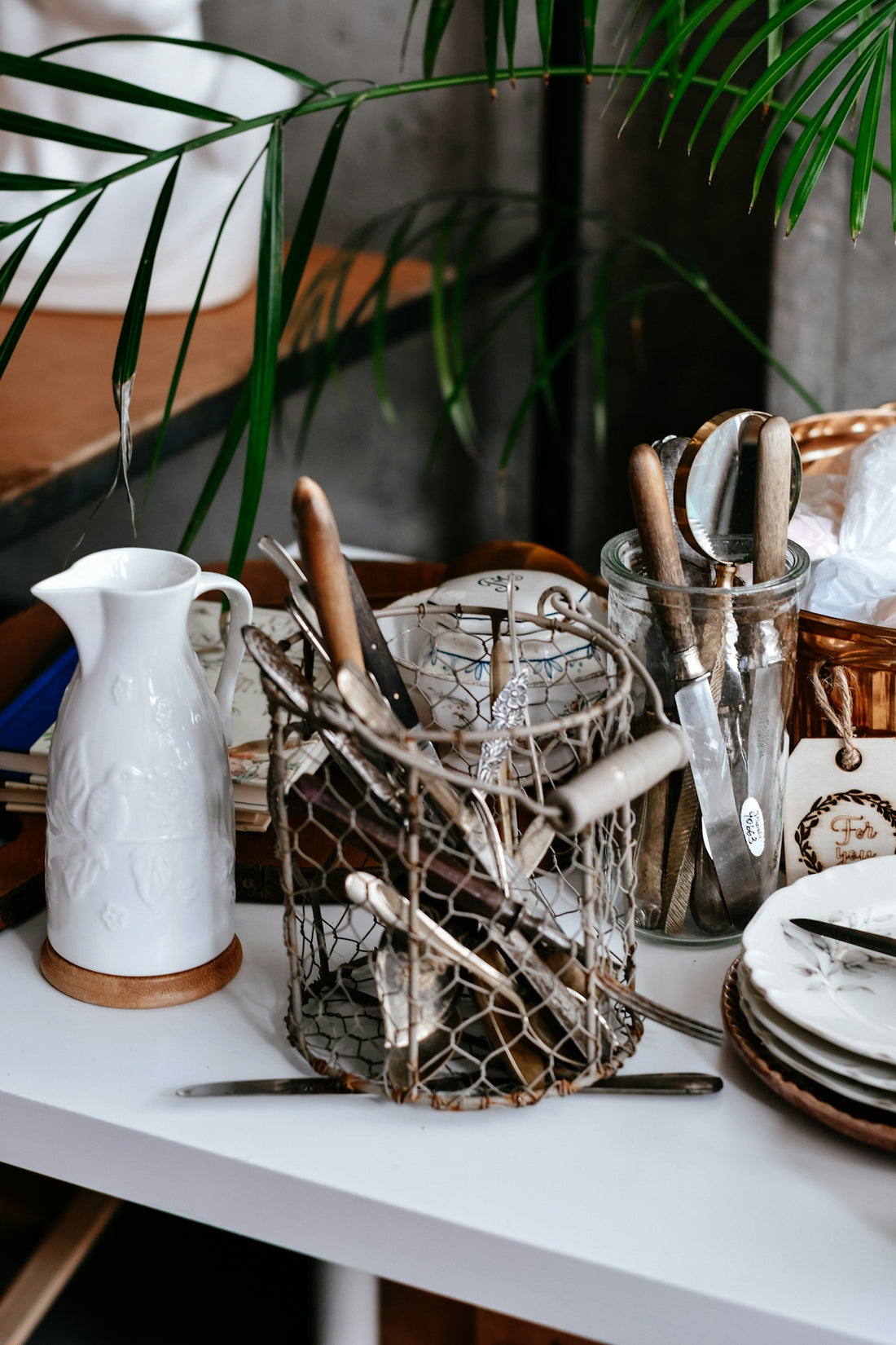 Kitchen utensils in wire holder with white pitcher