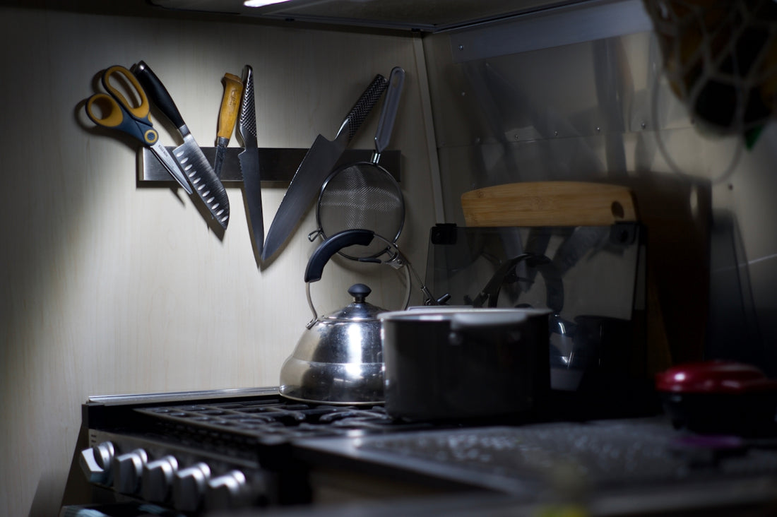 Kitchen counter with knives, scissors, and kettle