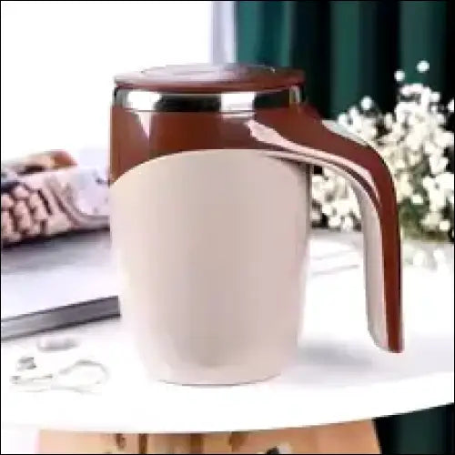 AutoStir coffee mug with lid, brown and white dual-tone design.