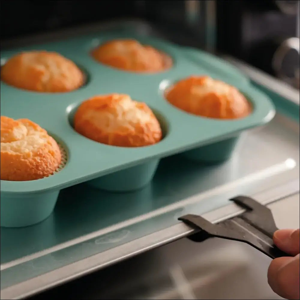 Freshly baked muffins in a blue silicone muffin tray by Chefio for baking. Muffin tray in the oven.