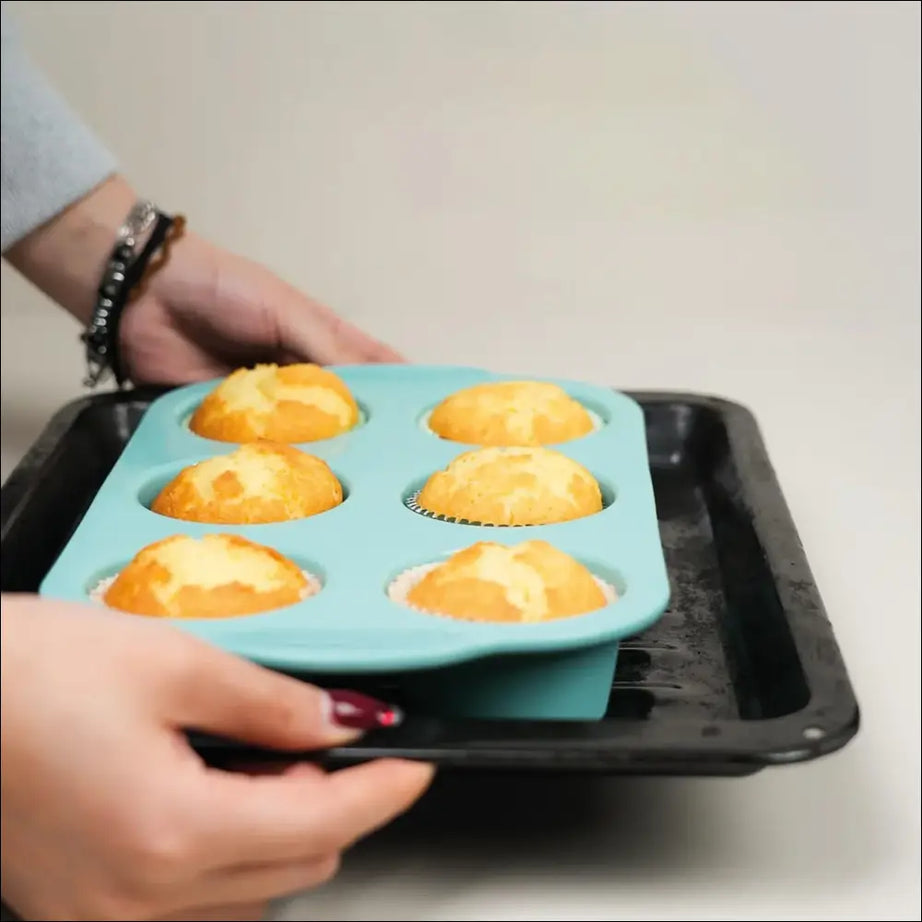 Freshly baked muffins in a silicone muffin tin, perfect homemade treats ready to enjoy after baking. Baking muffins.