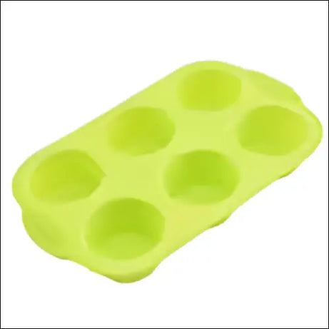 Light green silicone muffin tray with six round cavities.