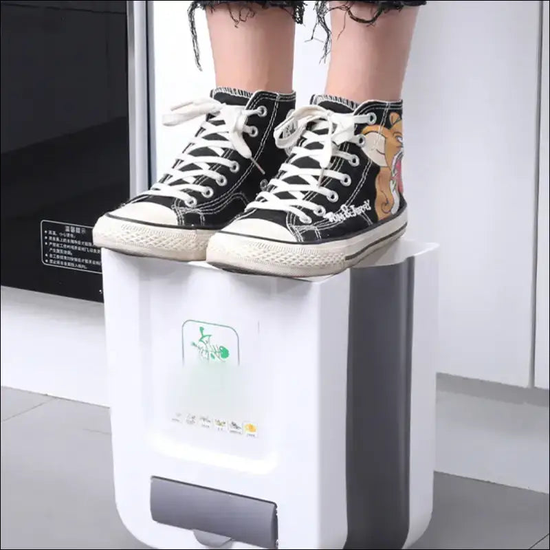 EcoFold Wall Bin: Wall-mounted kitchen trash can underfoot. Durable space-saving kitchen organizer by Chefio for small apartments.