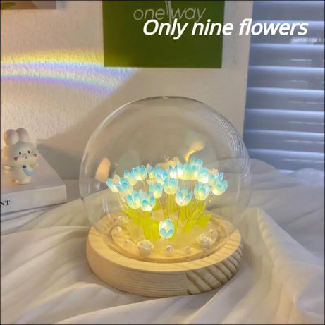 Luminous tulip dome with glowing flower lights inside glass.