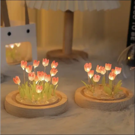Luminous tulip dome lamps with glowing tulips and wooden base.