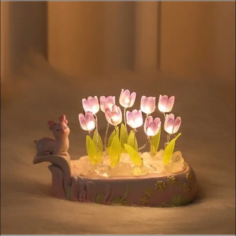 Glowing tulip dome with pink base and cute animal figurine.