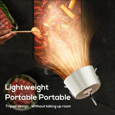Portable fan clearing smoke from a boiling pot; lightweight kitchen appliance.