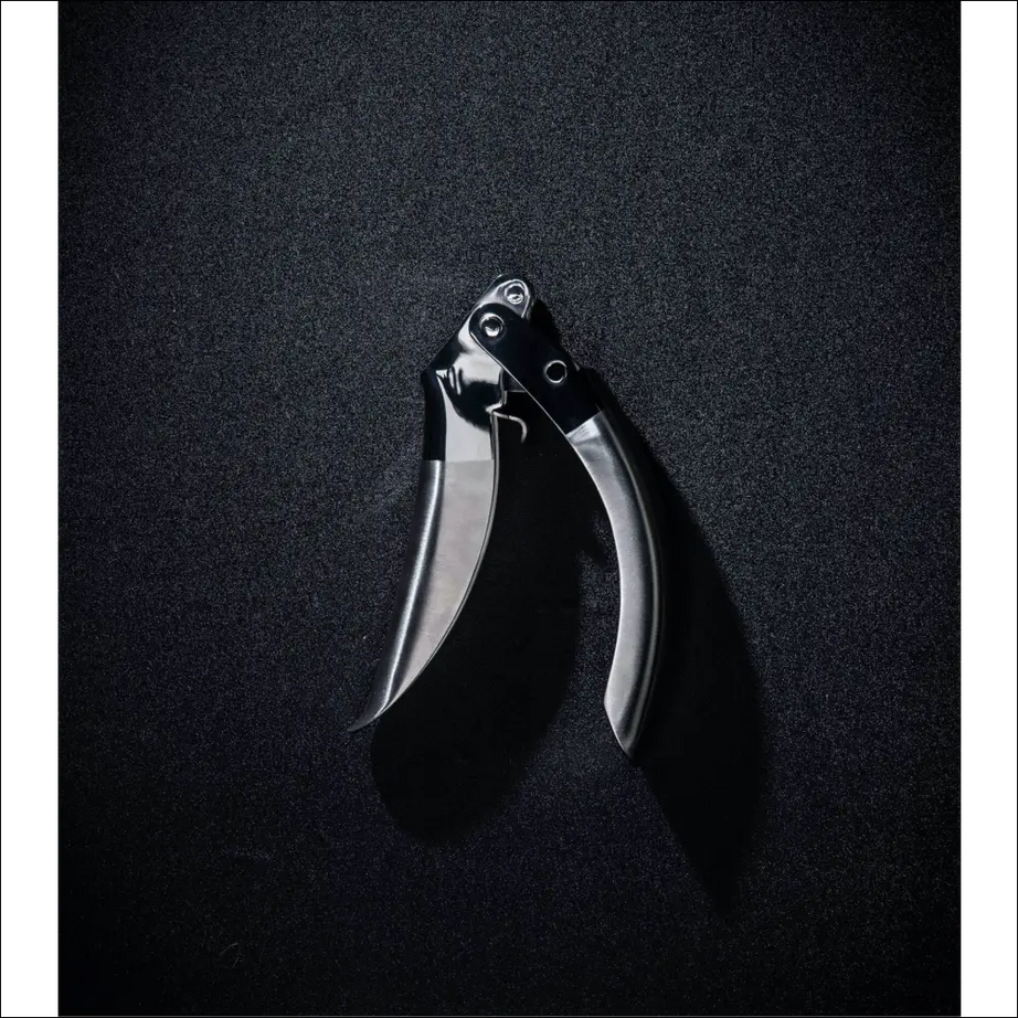 ProPress garlic crusher with a metallic finish on a dark background