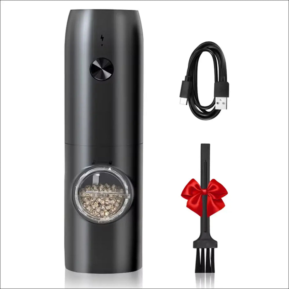 Black electric grinder with spices, charging cable and cleaning brush.